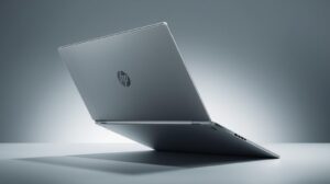 HP OmniBook X Flip 14 convertible 2-in-1 laptop folded in tent mode, featuring a 3K OLED touchscreen display and premium silver aluminum design
